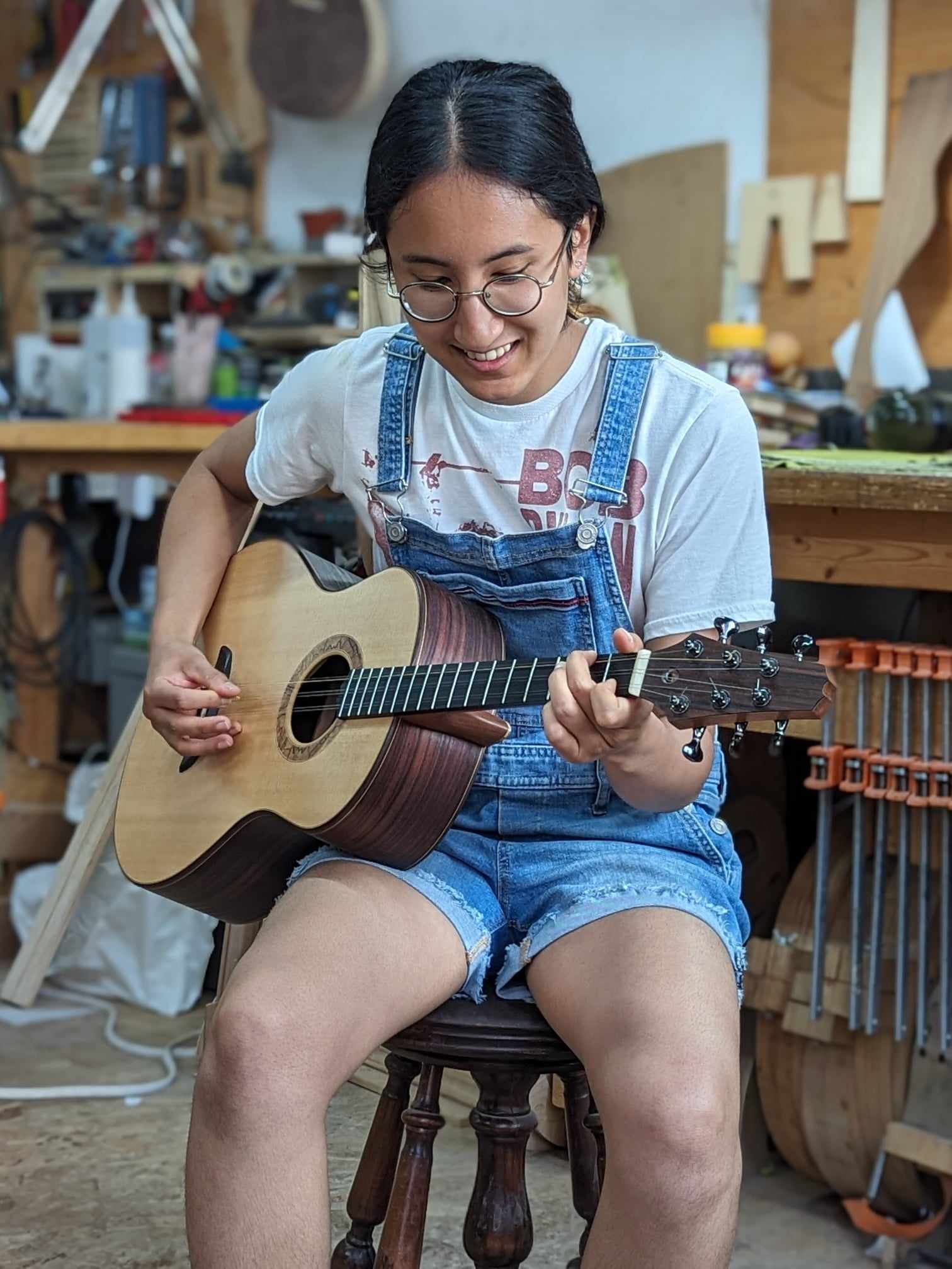 May playing the tres that she built.